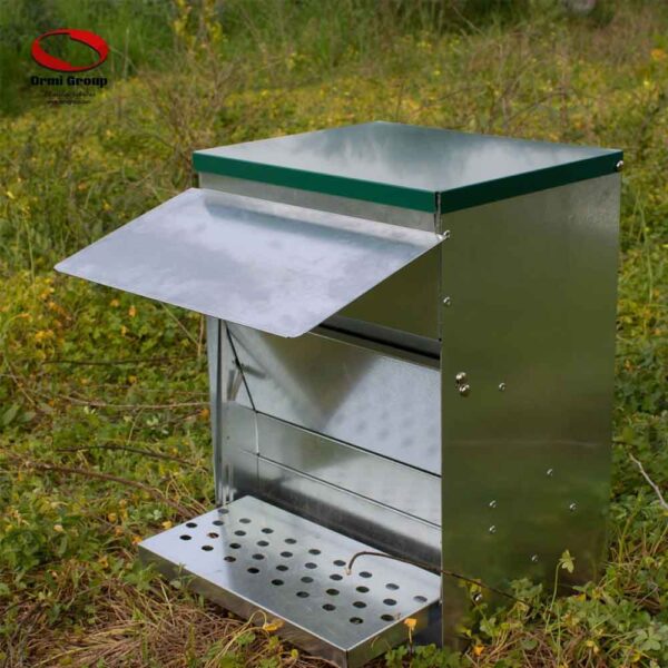 Treadle Poultry Feeder open in field